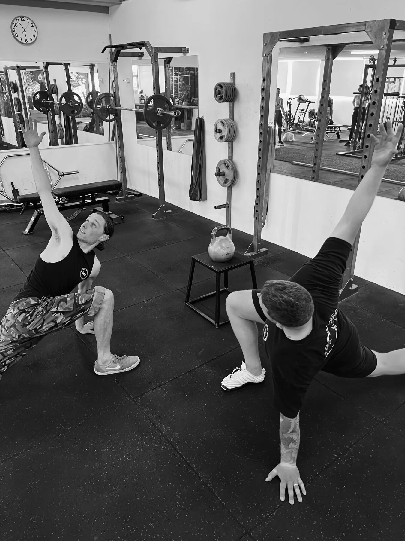 A client working through an overhead mobility drill with coaching.